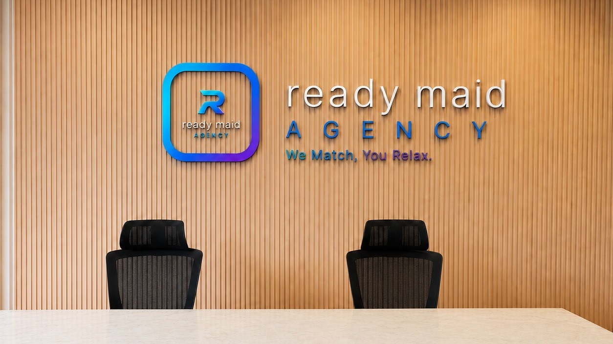 Ready Maid Agency reception with the official wall branding and meeting counter